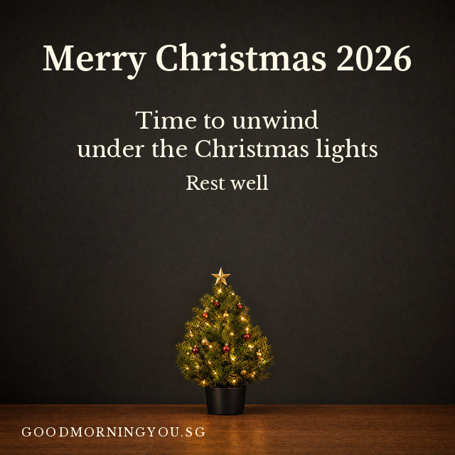 Merry Christmas card with a small lit Christmas tree in the dark