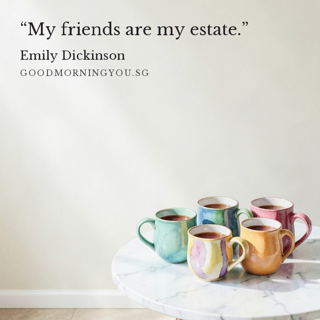Five mismatched colourful mugs gathered on a round marble table against a pale wall. “My friends are my estate.” — Emily Dickinson