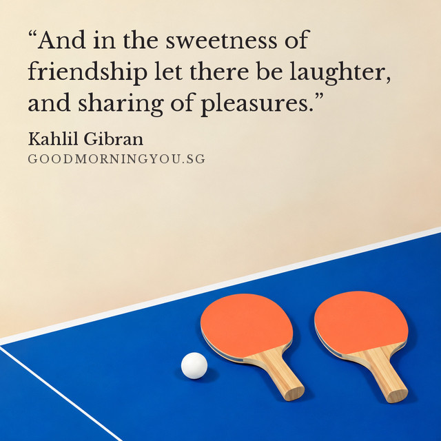 Two table-tennis paddles and a ball resting on a blue table. “And in the sweetness of friendship let there be laughter, and sharing of pleasures.” — Kahlil Gibran